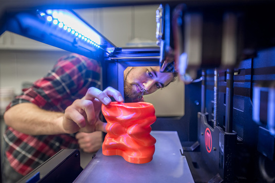 A student 3D printing an object