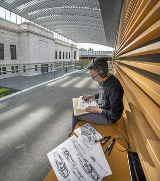 A student sketching cars in the Cleveland Museum of Art