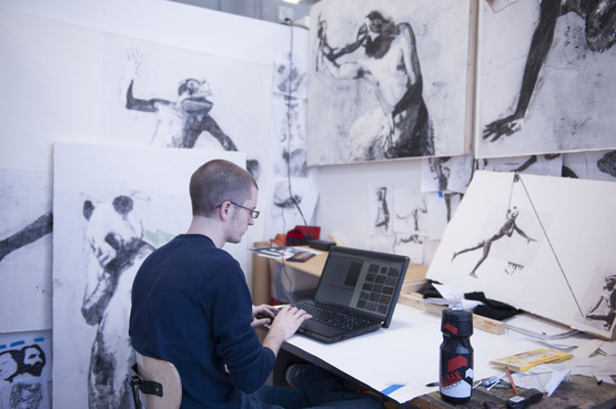 A student on his laptop in his studio