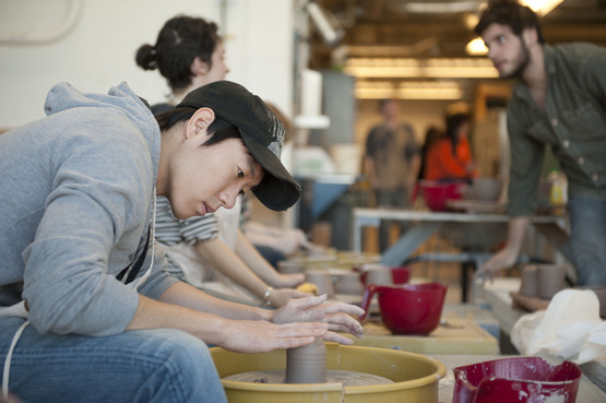 Students working at the potter's wheel
