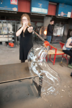 A student blowing glass