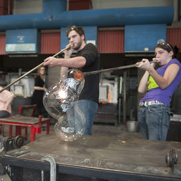 Image of student blowing glass