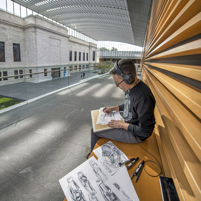 A student sketching cars in the Cleveland Museum of Art