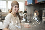 Image of a student with two blown glass bubbles