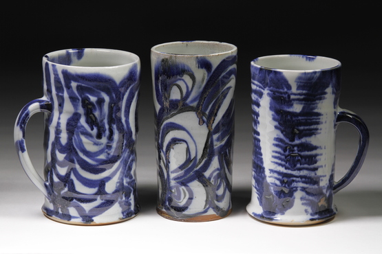 tall white ceramic mugs with blue painted design