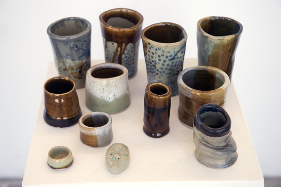 A group of various shaped and colored ceramic vessels. 