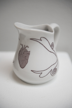 A ceramic vessel with glazed drawings created by a Pre-College student. 