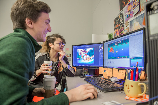 Students play testing a computer game. 