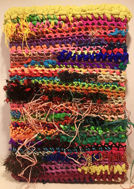 crotchet work using many colored yarns, beads, and raffia