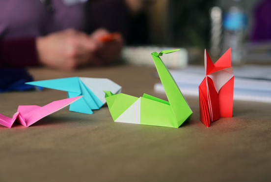 Folded paper pieces on display during an origami workshop. 