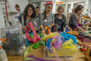 A group of teachers looking through a bin of felt during a one-day workshop. 