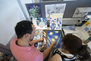 An instructor and student reviewing their work in an Illustration studio. 