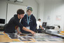 Students lay out various photos in the Photography course. 