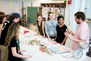 Students in the Print and Ceramics class gather around for a decal demo. 