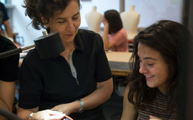 Pamela Argentieri reviews student's accessory design in the jewelry studio