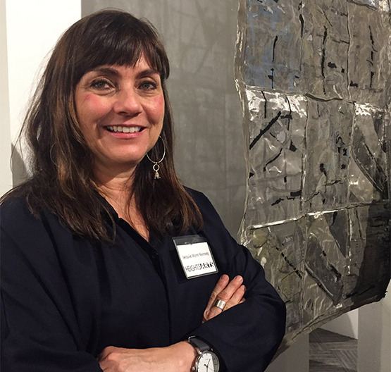 Jacquie Kennedy at an exhibition in front of her artwork